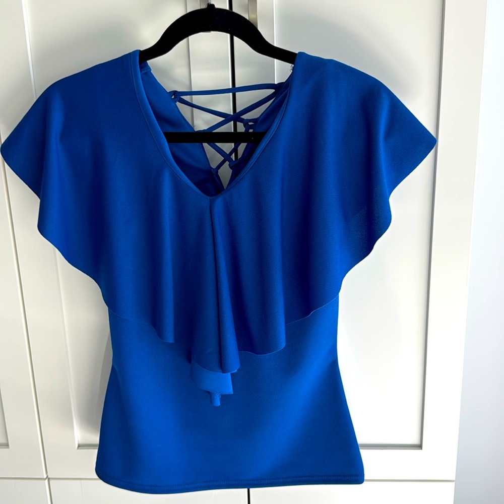 Blue fitted sleeveless top with flounce overlay